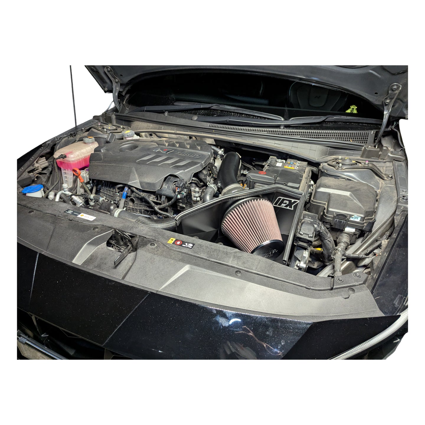 The IFX intake kit installed in an i30 Sedan N engine bay, showing the perfect clearance around the battery and factory ducting integration.