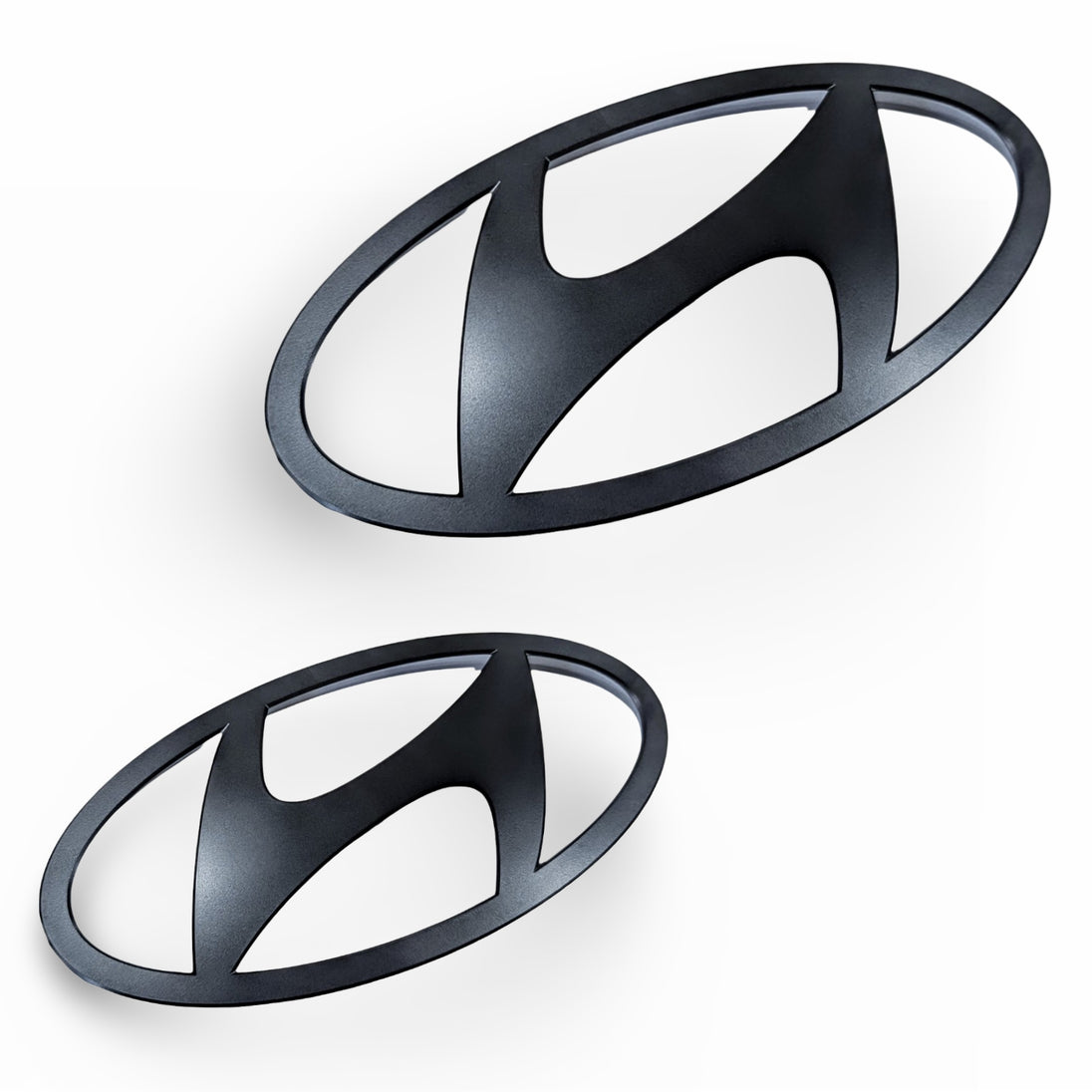 genuine Hyundai i30N Sedan and Elantra N gloss black emblem set, including the front and rear 'H' logos and 'N' branding for a complete de-chromed look.